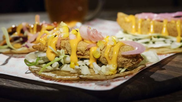 Fish tacos drizzled with sriracha mayo.