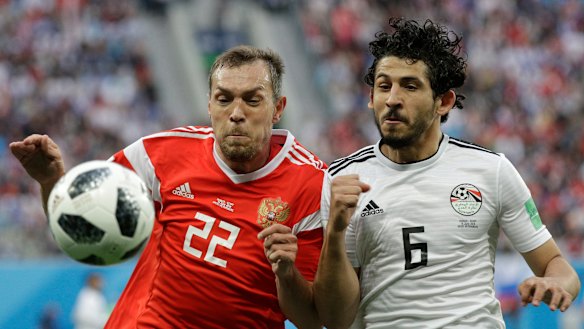 Physical battle: Artem Dzyuba and Ahmed Hegazy contest the ball.