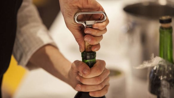 Winemakers uncork the vintage bottles before giving the owner a taste and re-corking.