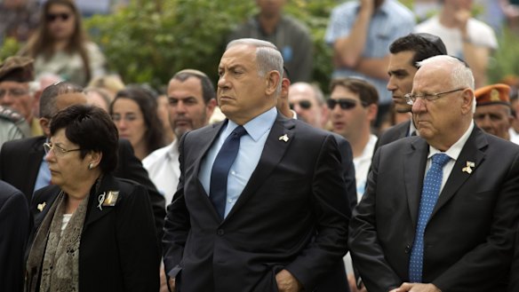 Israeli Prime Minister Benjamin Netanyahu (centre) stands with Israeli President Reuven Rivlin (right) during an official state Memorial Day service for the country's fallen soldiers and victims of terrorism.