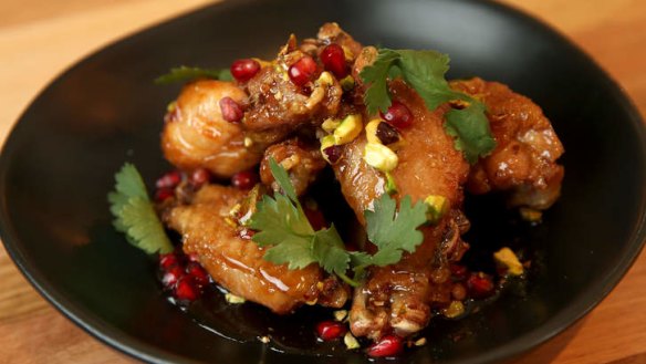 Twice-cooked chicken wings with pomegranate glaze and pistachios.