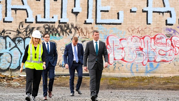 NSW Premier Mike Baird (right) arrives at the goods yard in Rozelle on Thursday to announce the extension.