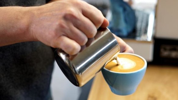 Barista Craig Simon pours the perfect latte.