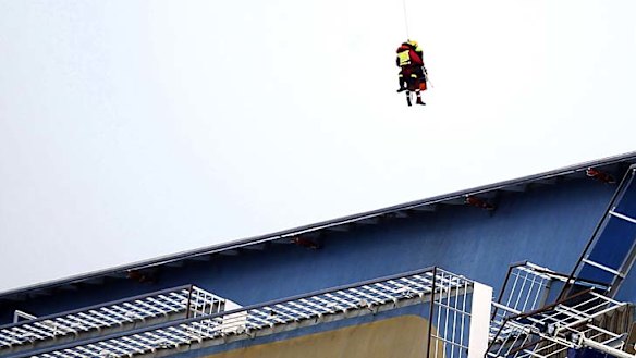 A,n Italian crew member is flown to safety after being rescued.