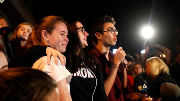 Diego Pfeiffer, a student survivor from Marjory Stoneman Douglas High School, speaking to a crowd of supporters and media, with fellow survivors Sophie Whitney, left, and Sarah Chadwick.