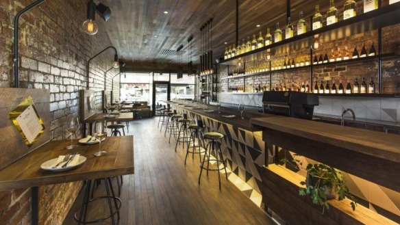 The Milton interior features exposed brick, and a timber ceiling.