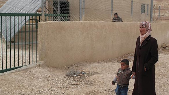 Mihad Moor, 25, and her son Mohammed at the solar panel station set to be demolished by the Israeli government.