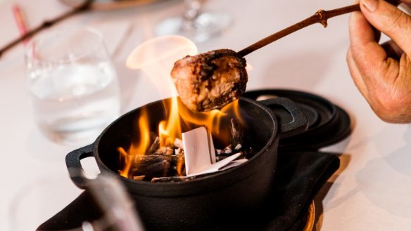 Chocolate marshmallows toasted over an at-table bonfire.