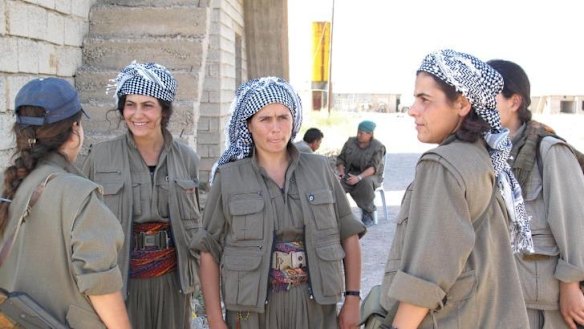 Commander Nuve Rojhat (centre) with some of the fighters in her unit at the Daquq PKK base.