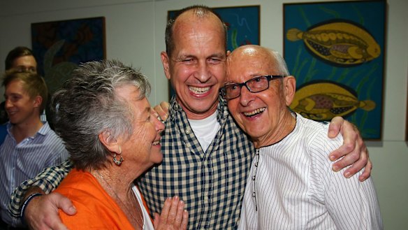 Welcome home son ... Australian journalist Peter Greste is hugged by his mother Lois, left, and father Juris, right, after his arrival in Brisbane.