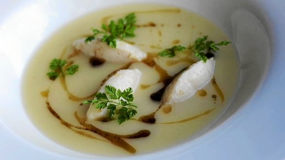 White fish veloute with sea bream quenelle black olives and chervil.