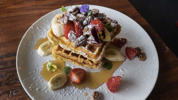 The waffle stack scattered with candied pecans.