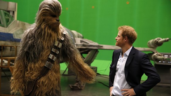 When Harry met Chewie ... Britain's Prince Harry gets some acting tips from Chewbacca during a tour of the Star Wars sets at Pinewood studios in Iver Heath, west London on April 19.