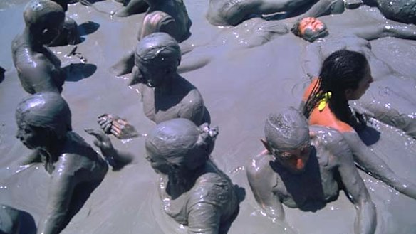 Soaking in it ... tourists laze in the volcanic mud.
