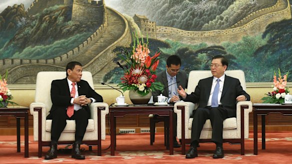 Philippine President Rodrigo Duterte, left, listens to Zhang Dejiang, chairman of the Standing Committee of the National People's Congress of China.