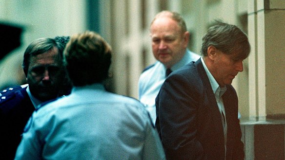 Bandali Debs is led into the court by security.