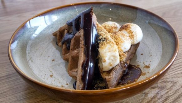 S'more ice-cream sandwich with torched marshmallow and chocolate fudge.