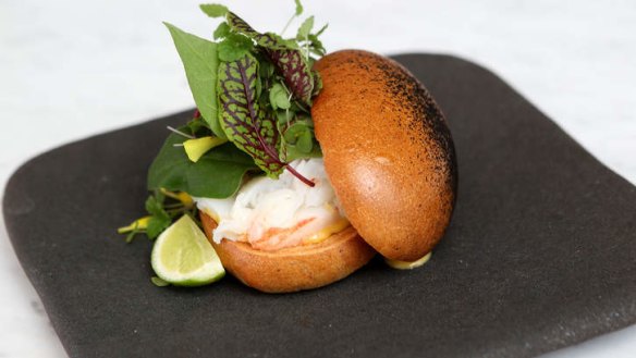 Charcoal-smeared brioche bun on Kettle Black's lobster roll in Melbourne.