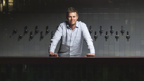 Mammoth venture: Lachlan Bird pictured with some of the 31 beer taps.
