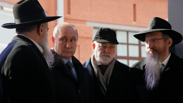 Russian President Vladimir Putin and, businessmen Viktor Vekselberg, second from right, 
stand next the stone of the memorial to members of the resistance at Nazis concentration camps during WW II, at the Jewish Museum and Center for Tolerance in Moscow, Russia in January. 