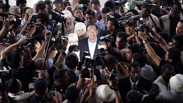 Then Malaysian opposition leader Anwar Ibrahim, centre, is surrounded as he arrives at court in 2008.