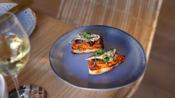 Anchovy, lardo and confit tomato on toast.