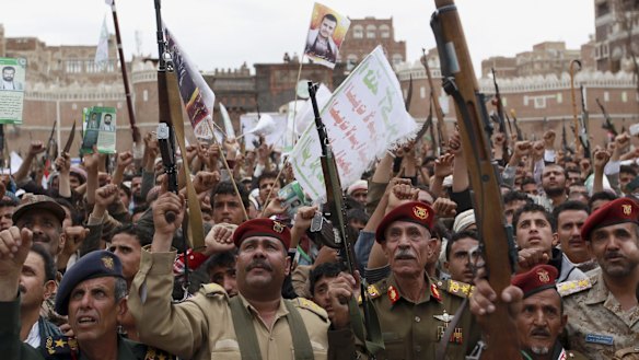 Houthi rebels hold up their weapons to protest against Saudi-led air strikes during a rally in Sana'a last week.