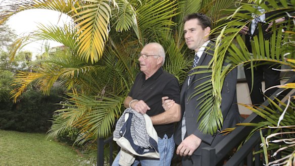 Detectives drag Roger Rogerson from his Padstow Heights home.