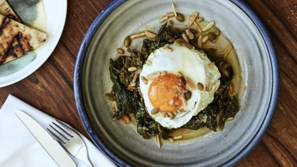 Wild greens braised in tomato, olive oil, grain, nuts, and fried eggs.