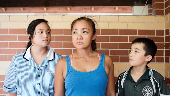 Sharon Eurlings, pictured at home with her children Aaliyah and Dylan, says proposed cuts to Sunday penalty rates are an "insult".