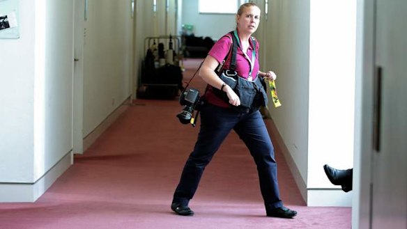 A News Corp Australia photographer loiters in the press gallery outside the office of Guardian Australia, waiting to photograph Editor-in-chief Katharine Viner, at Parliament House. Photo: Alex Ellinghausen