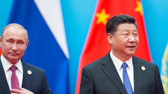 Chinese President Xi Jinping, right, and Russian President Vladimir Putin walk to attend talks at the Shanghai Cooperation Organisation.
