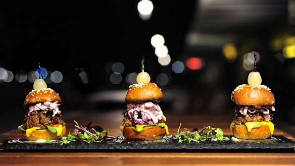 Barbecue beef sliders with apple coleslaw and cheese.