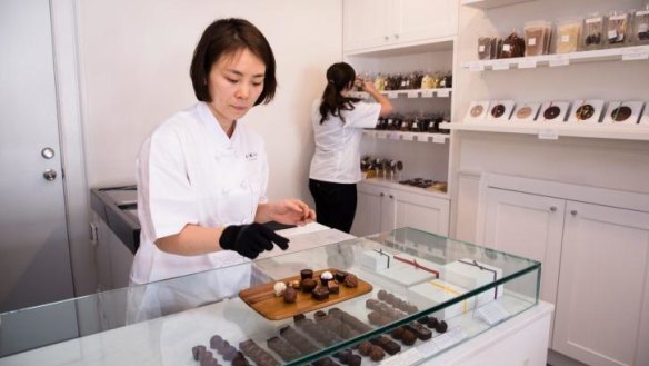 Jin Sun Kim, owner and head chocolatier, behind the counter of the new store.