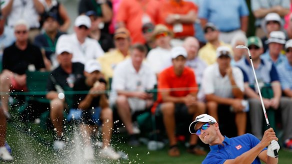 Still within striking distance: Adam Scott hits out of a bunker.