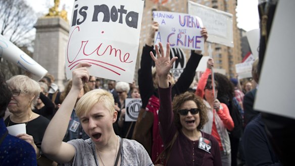 Demonstators at  rally in New York on Thursday protest against Republican presidential candidate Donald Trump's remarks about women and abortion. 