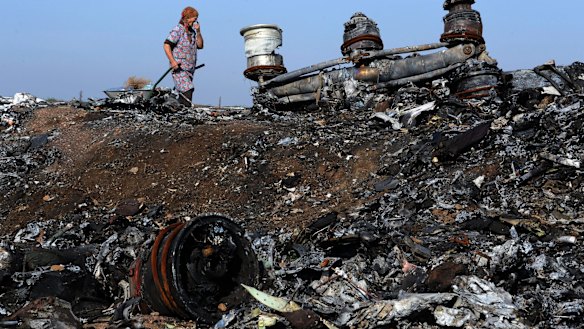 A woman walking among the wreckage of the MH17 crash site last week. 