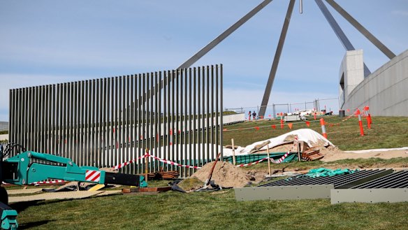 A security fence is installed across the lawns of Parliament House in Canberra.