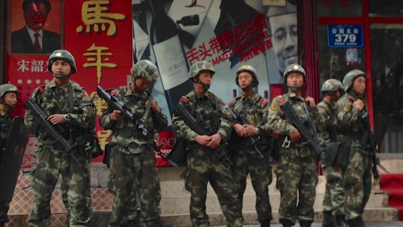 Armed police patrol the streets in Urumqi, Xinjiang, China.