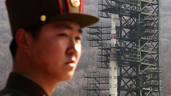 A North Korean soldier stands guard at the rocket site before the launch.