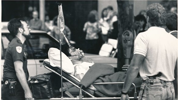 A victim of the shooting is taken away from the scene on a stretcher.