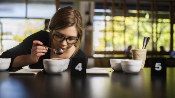 Caity Reynolds, head barista at The Cupping Room in Civic, tastes coffee for flavour.