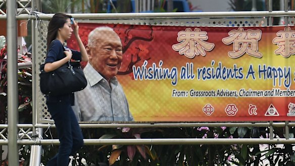 A pedestrian this week walks past a banner displaying an image of Singapore's founding father, Lee Kuan Yew.