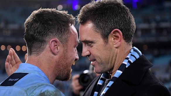 Emotional: James Maloney and coach Brad Fittler after the win.