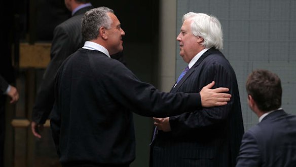 Palmer United Party leader Clive Palmer and Treasurer Joe Hockey depart after the Carbon Tax Repeal Bill passes the lower house. Photo: Alex Ellinghausen