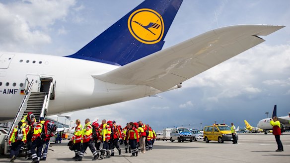 Members of a German rescue organisation board a plane at the airport in Frankfurt for Nepal. 