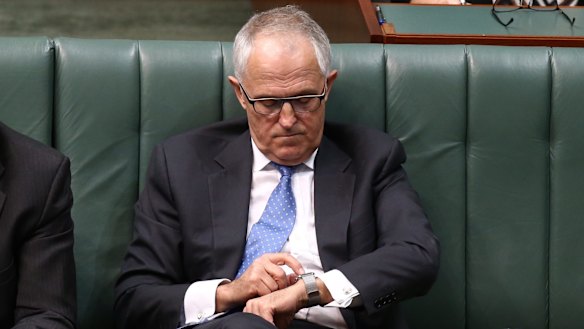Communications Minister Malcolm Turnbull adjusts his Apple watch during question time  on Thursday.