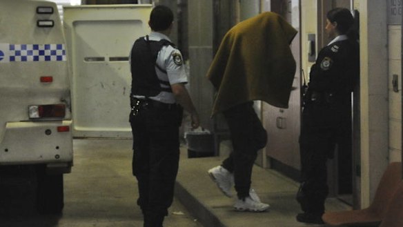 In court ... Kieran Loveridge is escorted to Burwood Court.