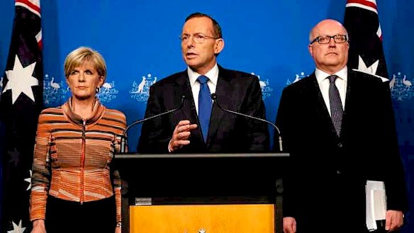 Prime Minister Tony Abbott with Foreign Minister Julie Bishop and Attorney-General Senator George Brandis in Canberra on Tuesday.