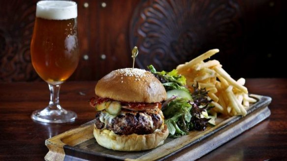 The classic combo of pub burger and beer at the East Village Hotel in Balmain.
